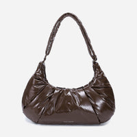 A glossy texture Croissant-shaped shoulder bag in glossy brown color by Dude & Bestie