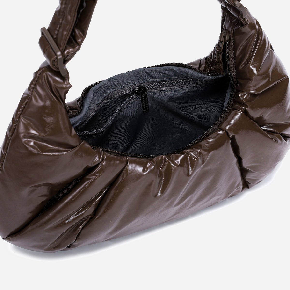 A glossy texture Croissant-shaped shoulder bag in glossy brown color by Dude & Bestie