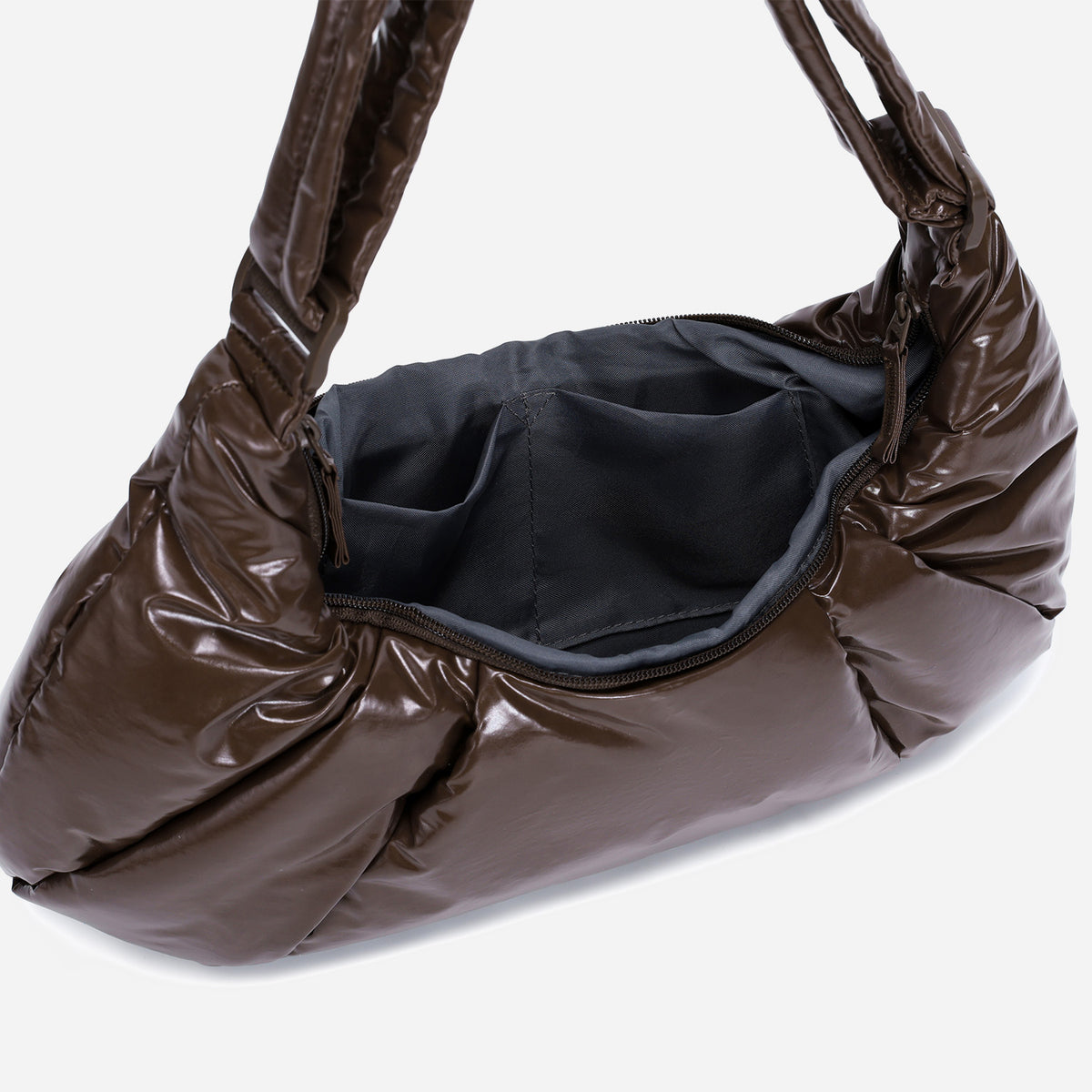 A glossy texture Croissant-shaped shoulder bag in glossy brown color by Dude & Bestie