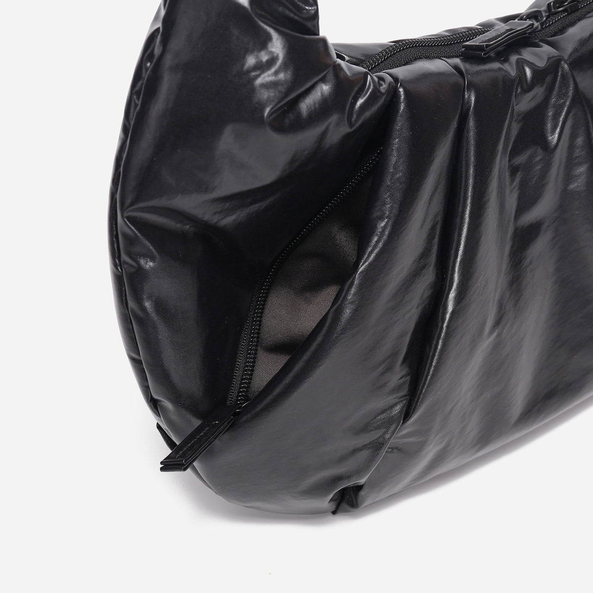 A black shiny Croissant-shaped shoulder bag with a single strap in polish black color